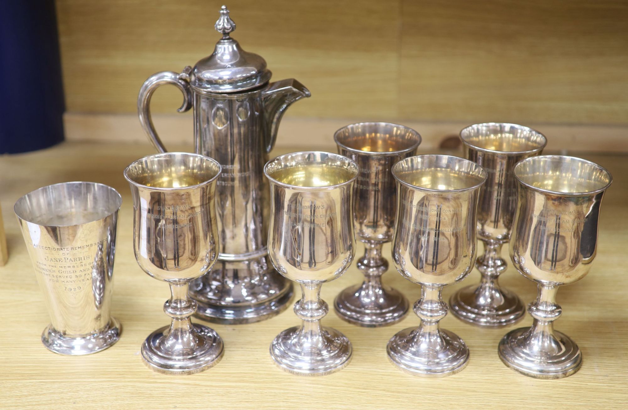 A Collis & Co Church silver plate lidded ewer, a set of six goblets from St Andrews Presbyterian Church, Eastbourne and a communion cup